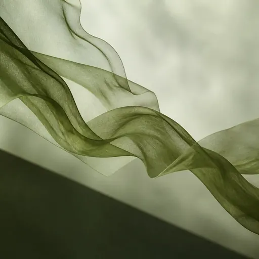 Translucent green fabric flowing through still air